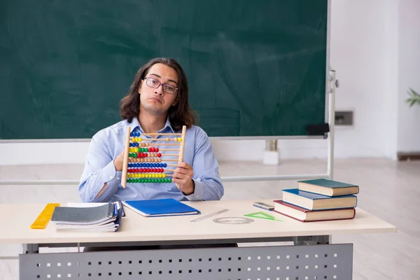 Jonge mannelijke leraar in de voorkant van groene boord — Stockfoto