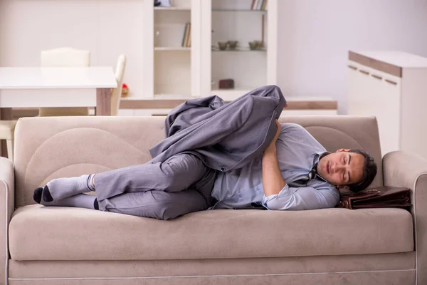 Tired young businessman coming home after working day — Stock Photo, Image