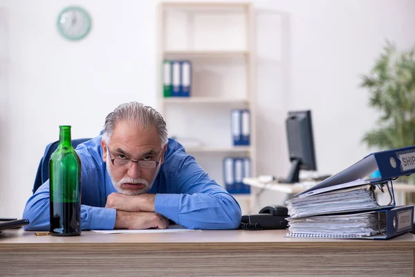 Un vieil employé boit de l'alcool au bureau — Photo