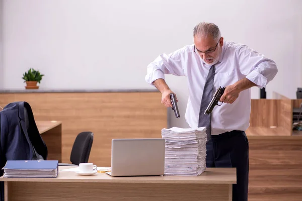 Viejo empleado sosteniendo arma infeliz con trabajo excesivo — Foto de Stock