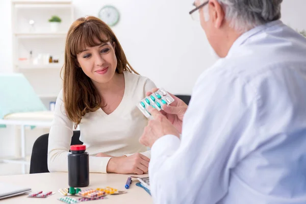 Jovem mulher visitando médico experiente — Fotografia de Stock