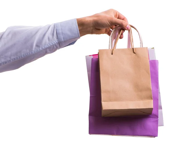 Mano sosteniendo bolsas de compras con compras de Navidad en la espalda blanca —  Fotos de Stock