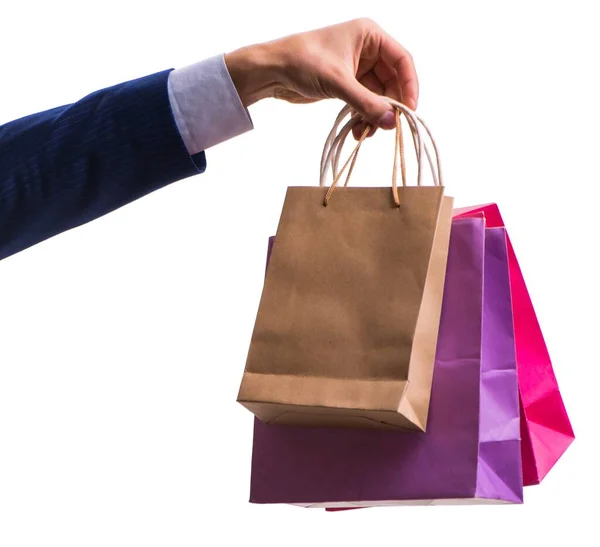 Hand holding shopping bags with christmas shopping on white back — Stock Photo, Image