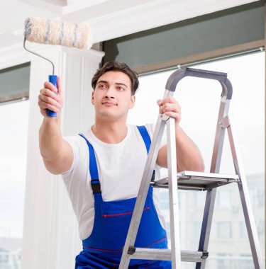 İnşaat alanında çalışan bir boyacı.