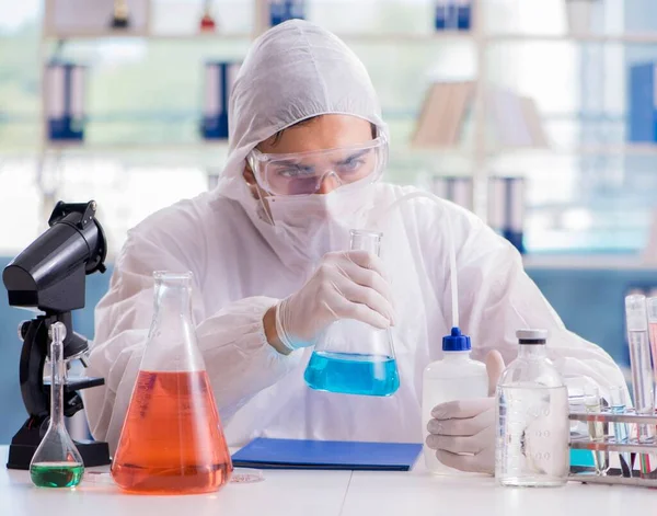 Chemist working in the laboratory with hazardous chemicals - Stock Image -  Everypixel