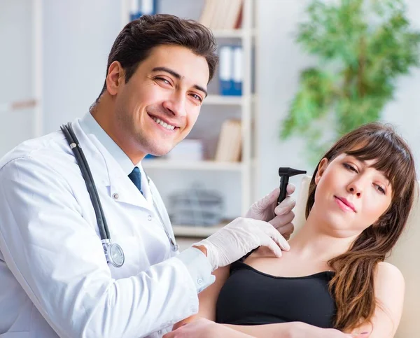 Doctor checking patients ear during medical examination