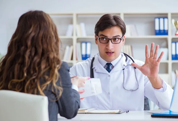 Young doctor in medical insurance fraud concept — Stock Photo, Image