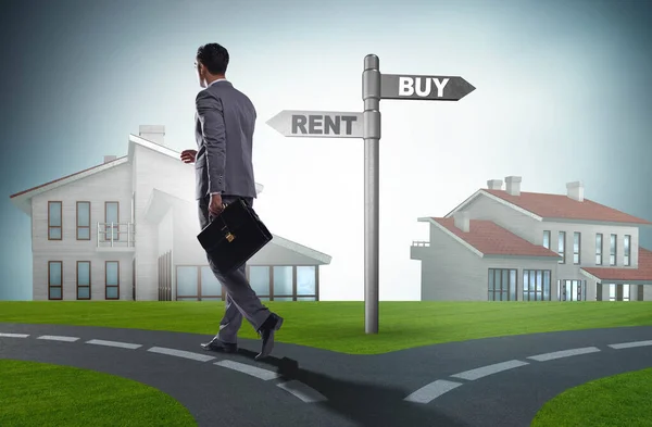 Businessman at crossroads betweem buying and renting — Stock Photo, Image