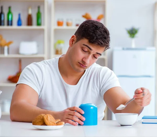 Человек засыпает во время завтрака после сверхурочной работы — стоковое фото