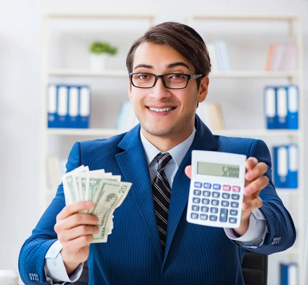 Accountant calculating dollars with calculator in office — Stock Photo, Image