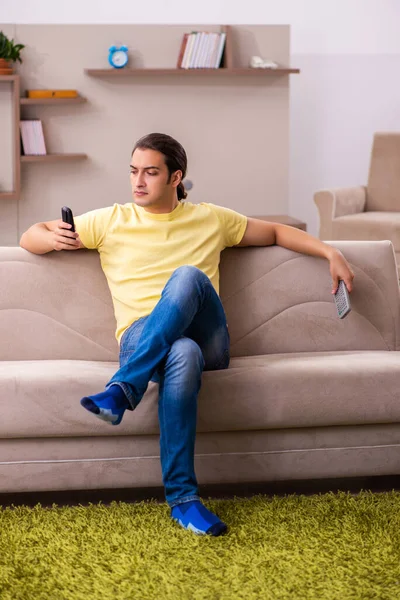 Young man student boring at home during pandemic