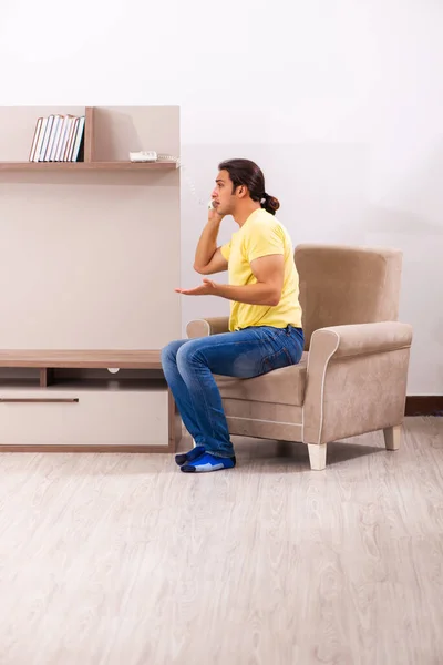 Joven estudiante hablando por teléfono en casa — Foto de Stock