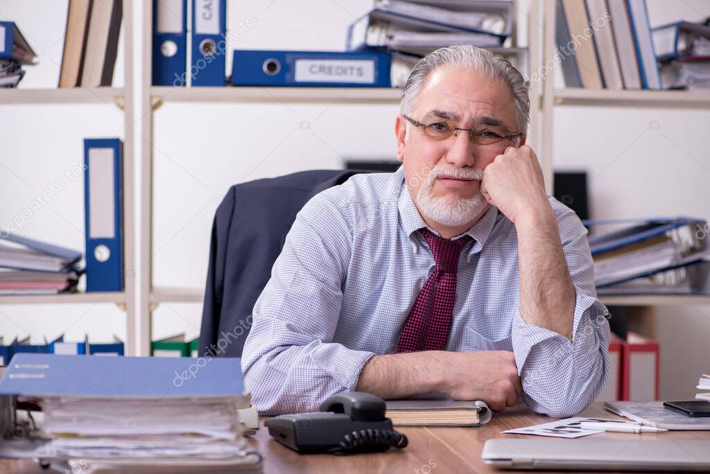 Old male employee unhappy with excessive work