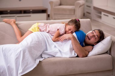 Young man with his daughter at home clipart
