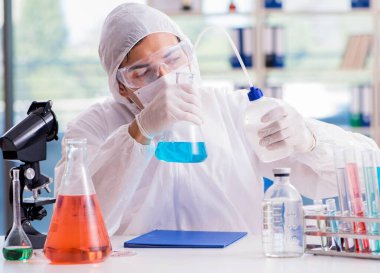 Laboratuvarda zehirli kimyasallarla çalışan bir kimyager.