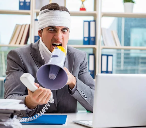 Injured businessman working in the office — Stock Photo, Image