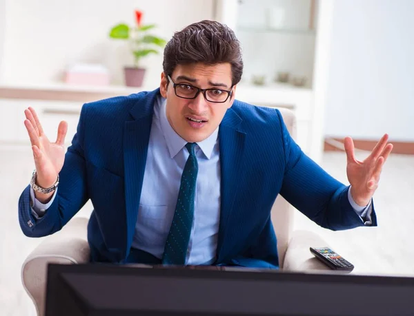 Businesman watching tv in office — Stock Photo, Image