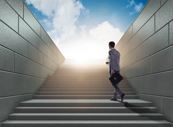 Businessman climbing up challenging career ladder in business co — Stock Photo, Image