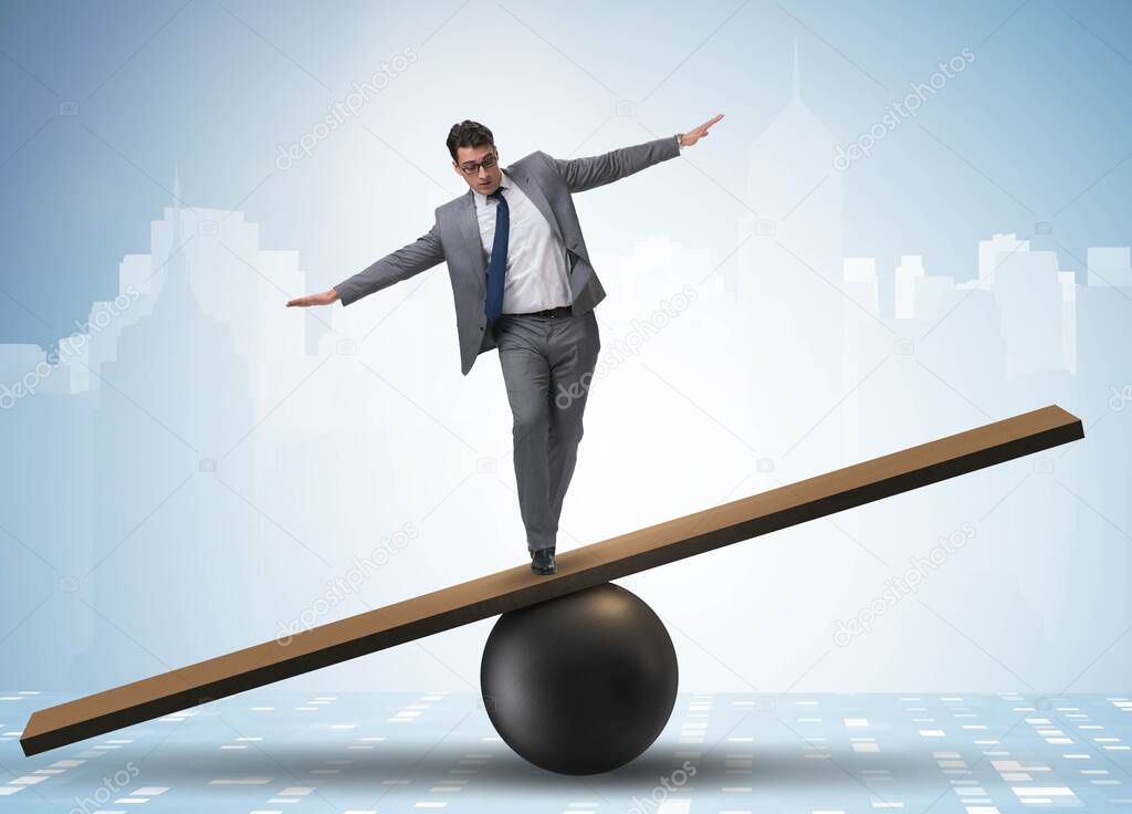 Businessman trying to balance on ball and seesaw