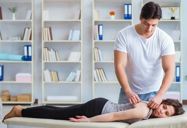 Young doctor chiropractor massaging female patient woman — Stock Photo, Image