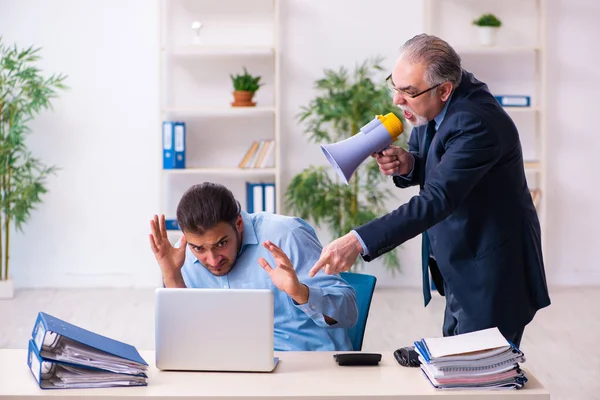 Old boss and his young assistant in the office — Stock Photo, Image