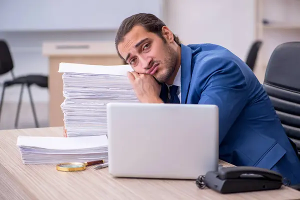 Jeune employé masculin et trop de travail au bureau — Photo