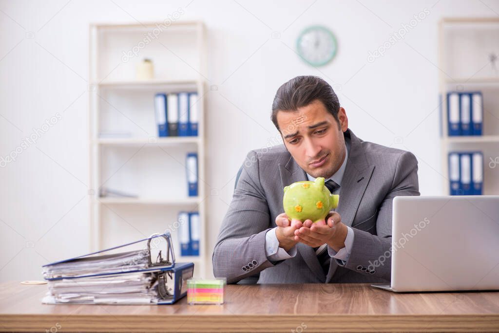 Young male employee in pension concept at workplace