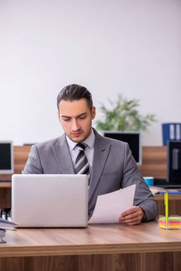 Ofiste çalışan genç bir erkek.