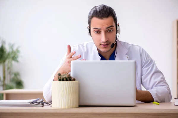 Young male doctor in telemedicine concept — Stock Photo, Image