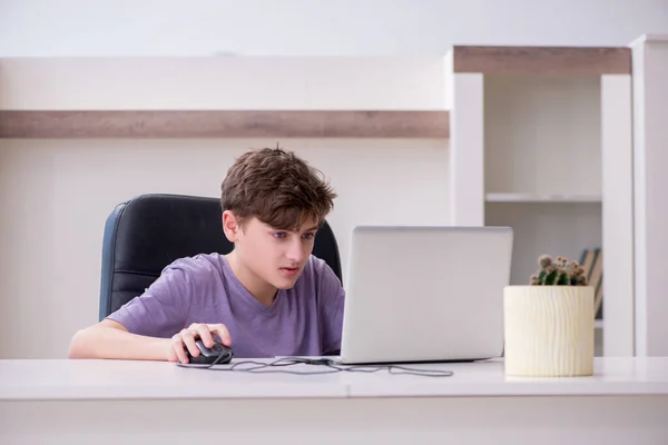 Schooljongen speelt computerspelletjes thuis — Stockfoto