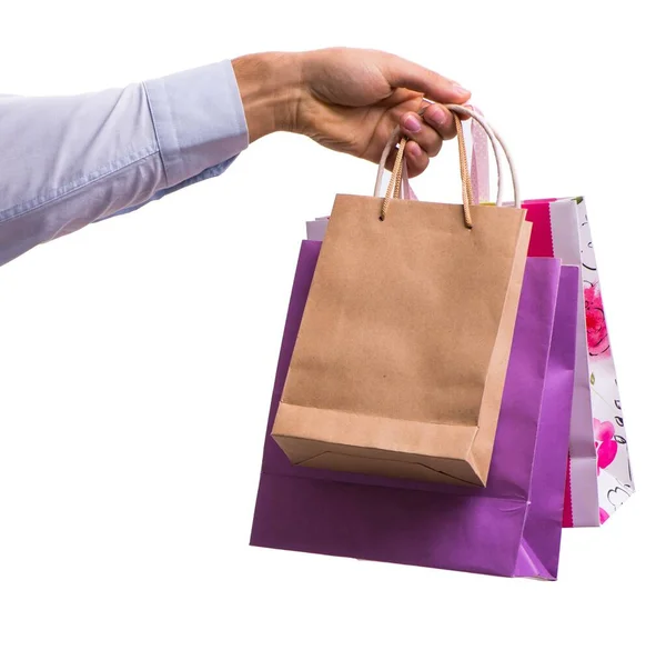 Hand holding shopping bags with christmas shopping on white back — Stock Photo, Image