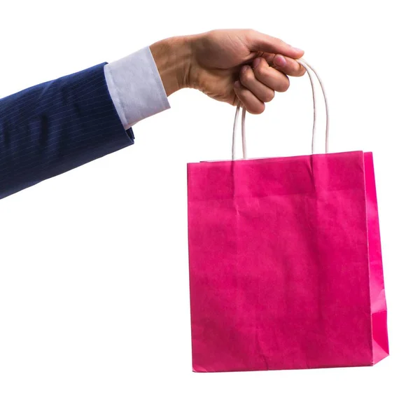 Mão segurando sacos de compras com compras de Natal na parte traseira branca — Fotografia de Stock
