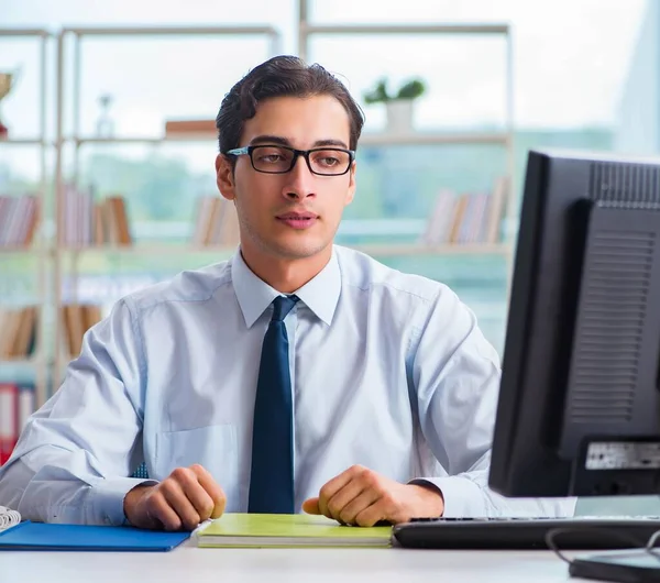 Unhappy businessman sitting at desk in office — Stock Photo, Image