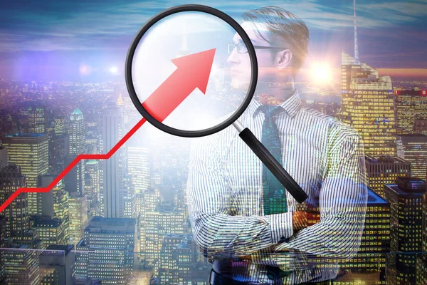 Concept of economic growth with chart and magnifying glass