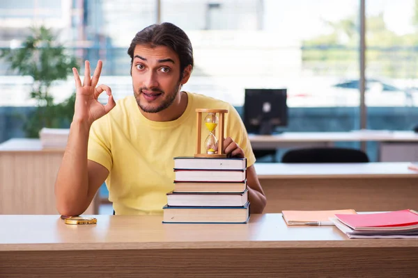 Young male student preparing for exams in time management concept — Stock Photo, Image