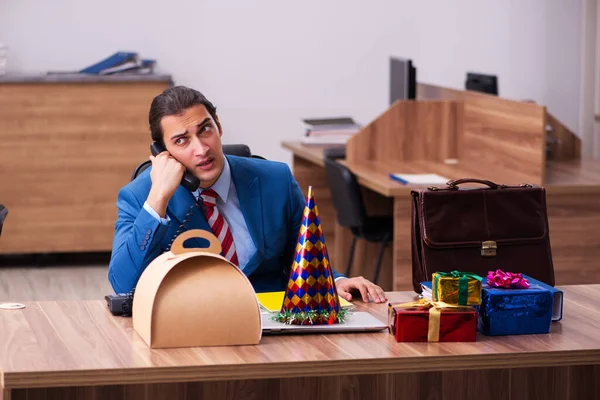 Young male employee celebrating Christmas at workplace — Stock Photo, Image