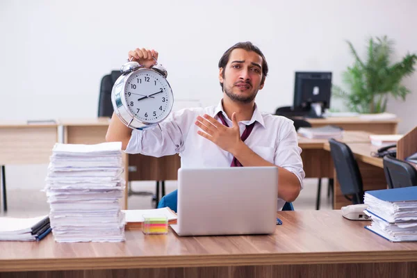 Jovem empregado do sexo masculino no conceito de gerenciamento de tempo no escritório — Fotografia de Stock