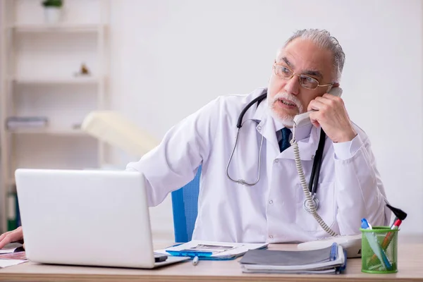 Velho médico masculino no conceito de telemedicina — Fotografia de Stock