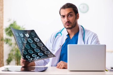 Klinikte çalışan genç bir erkek radyolog.