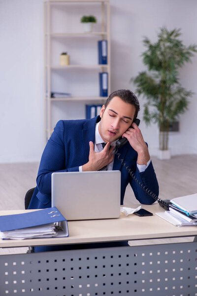 Sick male employee suffering at workplace