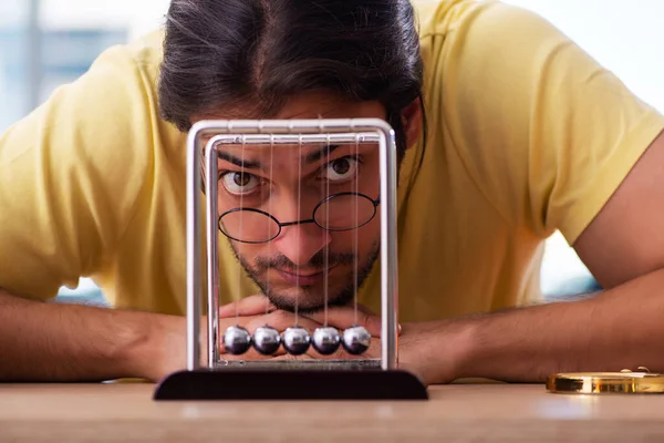 Young male student physicist preparing for exams in the classroom — Stock Photo, Image