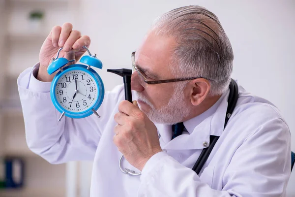 Old male doctor in time management concept — Stock Photo, Image