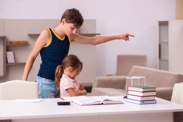 Skolpojke och hans lillasyster stannar hemma under pandemin — Stockfoto