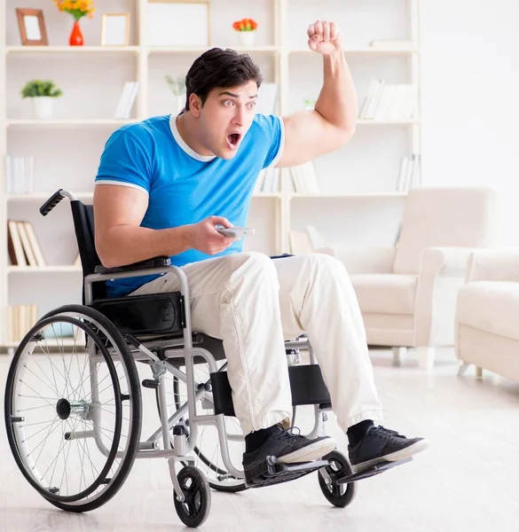 Disabled man watching sports on tv — Stock Photo, Image