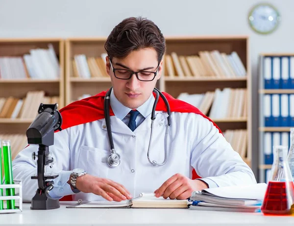 Superhero doctor working in the hospital lab