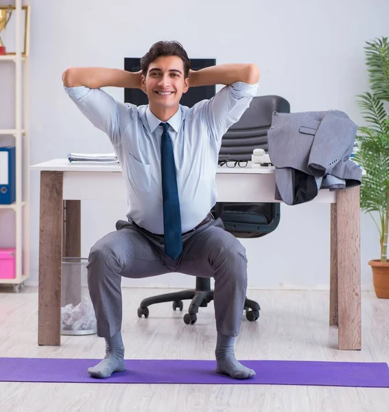 Businessman doing sports in office during break — Stock Photo, Image