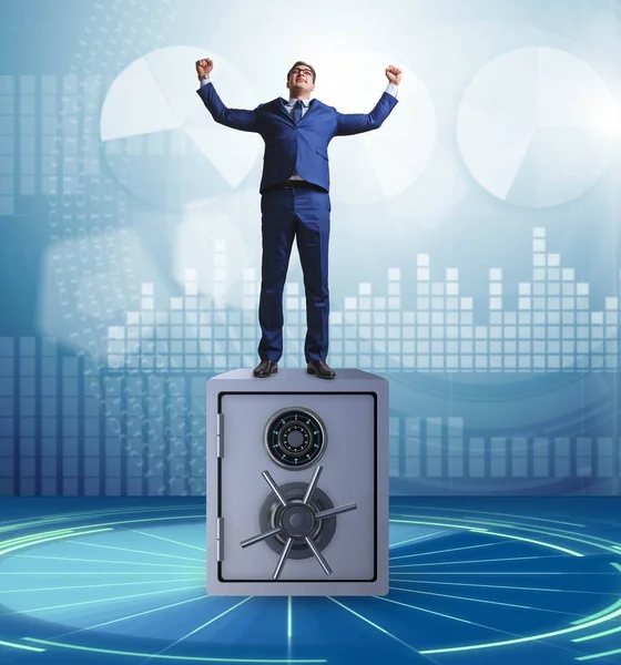 Businessman standing on top of safe — Stock Photo, Image