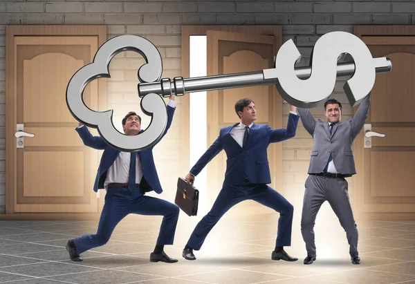 Businessmen holding giant key in finance concept — Stock Photo, Image