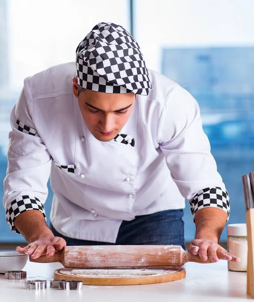 Giovane uomo che cucina biscotti in cucina — Foto Stock