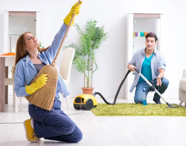 Jovem família limpando a casa — Fotografia de Stock